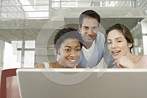 Business People Using Laptop In Conference Room