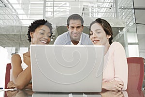 Business People Using Laptop At Conference Table