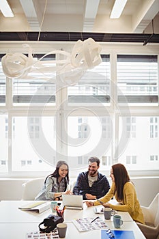 Business people using laptop in meeting room