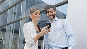 Business people using phone near office on street