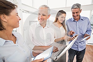 Business people using several electronic devices