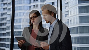 Business people using tablet computer in office. business partners talking