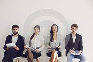 Business people waiting for job interview recruitment sitting on a chair in the office.