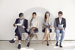 Business people waiting for job interview recruitment sitting on a chair in the office.