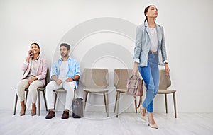 Business people, waiting room and chairs in hiring, row or opportunity together at office. Group of employees sitting in