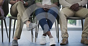 Business people, waiting room and legs in row for group seminar, workshop or meeting presentation at the office