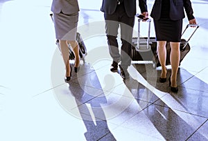 Business people walking with their suitcase in airport