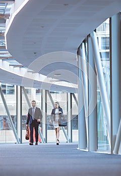 Business people walking together in the corridor at modern office building