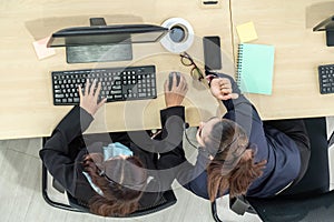 Business people wearing headset from top view in office working with computer