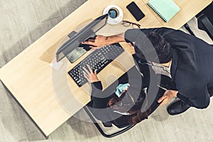 Business people wearing headset from top view in office working with computer