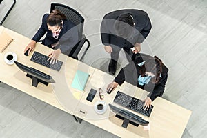 Business people wearing headset from top view in office working with computer