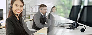 Business people wearing headset working in office broaden view