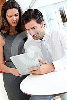 Business people websurfing on tablet
