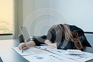 Business people who are tired from work and fall asleep at the office desk