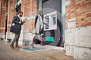 Business people withdrawing the money at the ATM photo