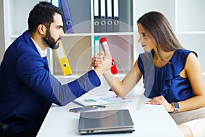 Business people woman and man arm wrestling