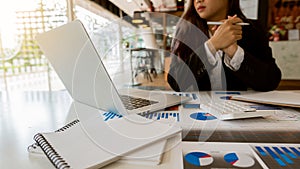 Business people work in the office with laptop data analysis graph documents on their desks