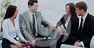 Business people working around table in modern office