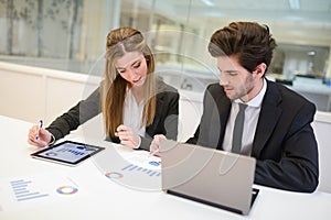 Business people working around table in modern office