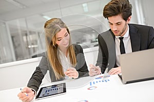 Business people working around table in modern office