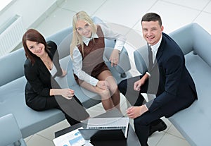 Business people working around table in modern office