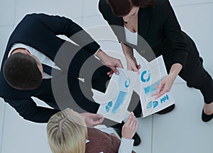 Business people working around table in modern office. Top view.