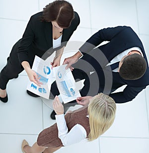 Business people working around table in modern office. Top view.