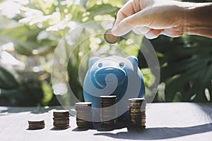 business people working at desk with piggy bank box.business finance saving and investment concept. hand put money coin into piggy