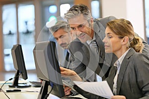 Business people working at office on desktop computer