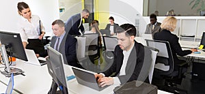 Business people working in open plan office