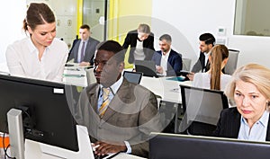 Business people working in open plan office