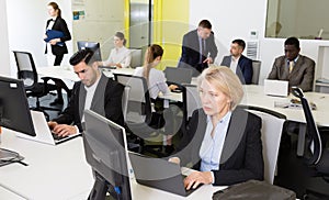 Business people working in open plan office