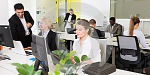 Business people working in open plan office