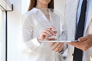 Business people working with tablet in office, closeup