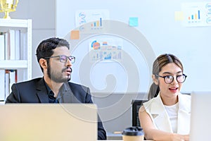 Business people working together with laptop computers on the desk in the office, businesswoman and businessman checking documents