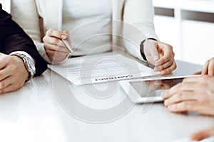 Business people working together at meeting in modern office. Unknown businessman and woman with colleagues or lawyers