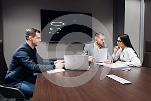 Business people working together on their laptop in a meeting room