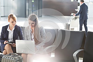 Business people working while waiting for boarding in the airport