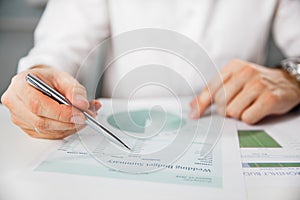 Business person analyzing financial statistics displayed on the tablet screen