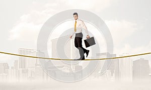 Business person balancing on golden rope