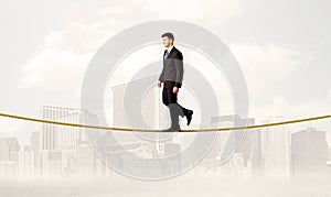 Business person balancing on golden rope