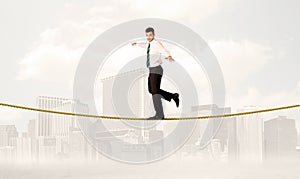 Business person balancing on golden rope