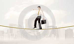 Business person balancing on golden rope