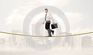 Business person balancing on golden rope