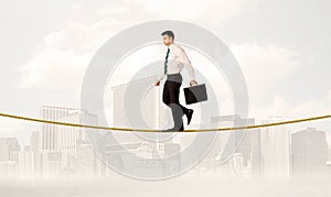 Business person balancing on golden rope