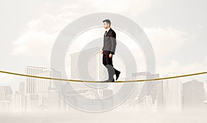 Business person balancing on golden rope