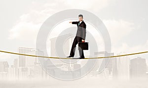 Business person balancing on golden rope