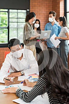 Business person brainstorm in meeting room with face mask