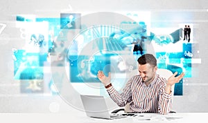 Business person at desk with modern tech images at background