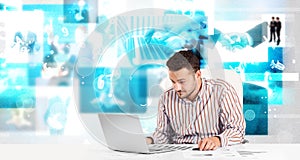 Business person at desk with modern tech images at background